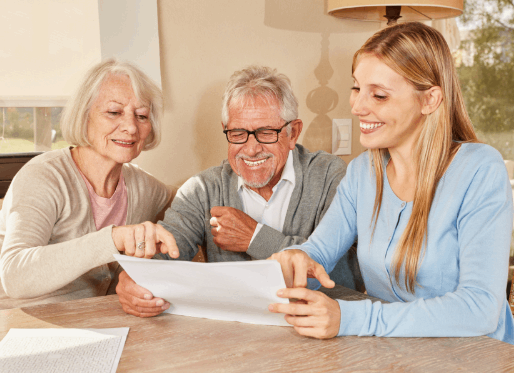 Ginny's Girls team member reviewing plans with a couple at home